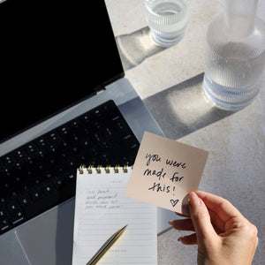 Laptop, planner, and handwritten note saying “You were made for this”—encouragement for women navigating pelvic floor recovery.