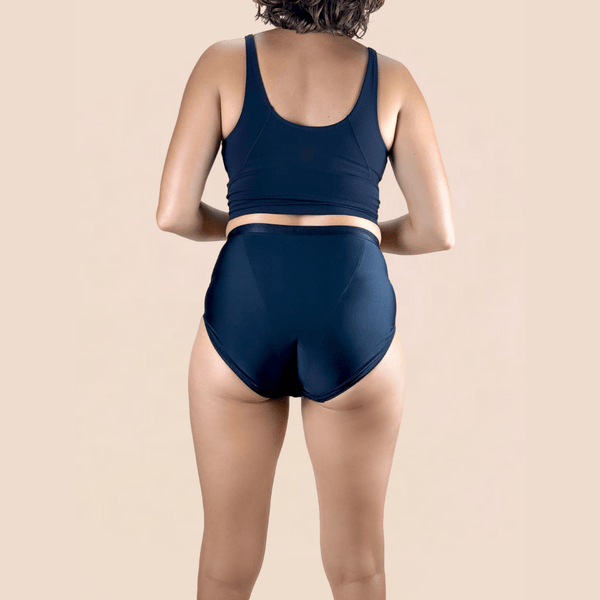 A woman shown from the back wearing Hem Support Wear's High Waisted Brief Pelvic Floor Support Underwear in black