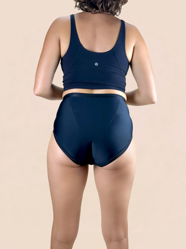Model shows back view of Hem Support wear's prolapse support underwear